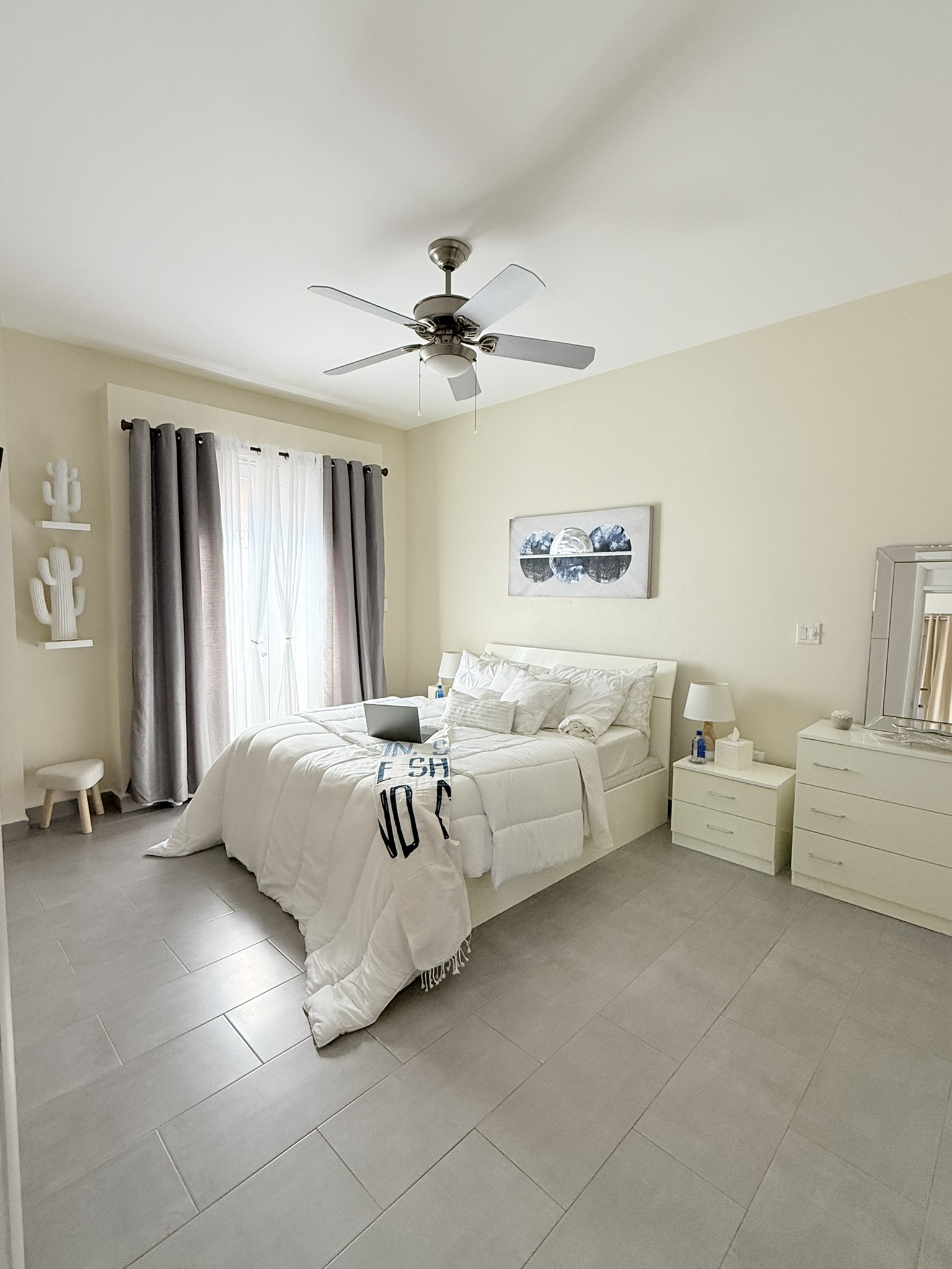 Bedroom with ceiling fan and king bed